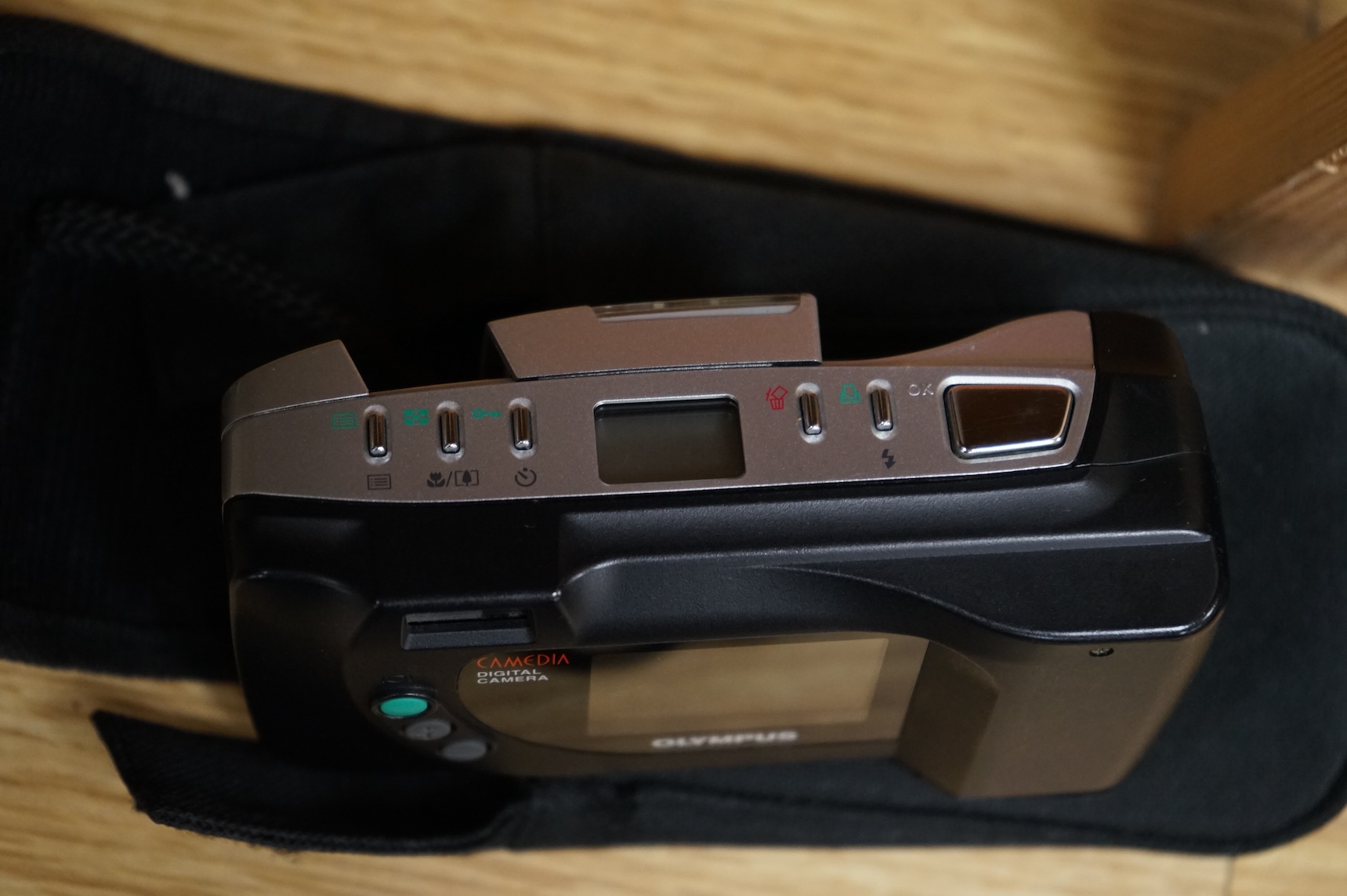 A cased Olympus 35SP camera, together with two more recent digital cameras